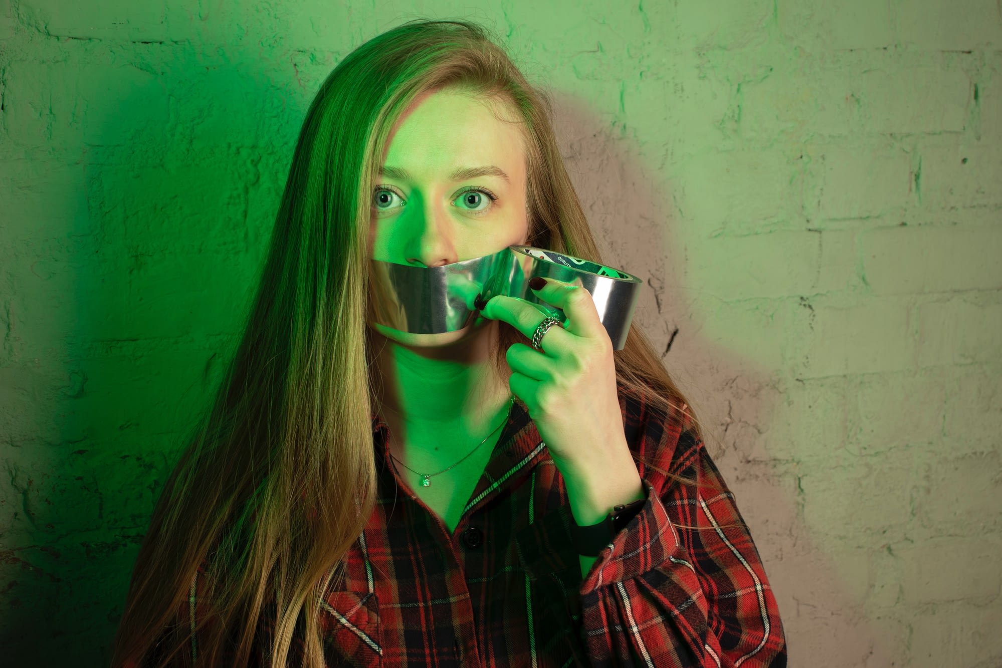 Woman with duct tape over her mouth